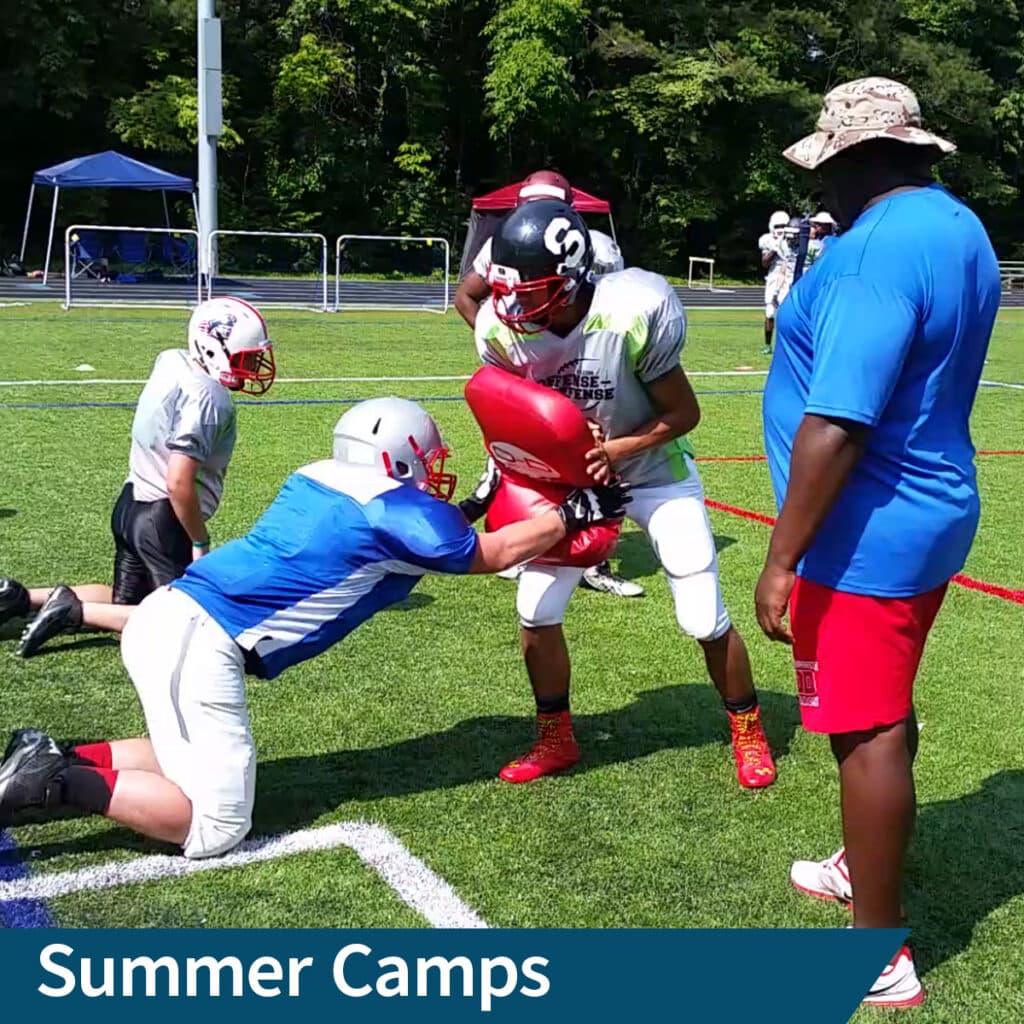 A contact drill under a coach at summer camp