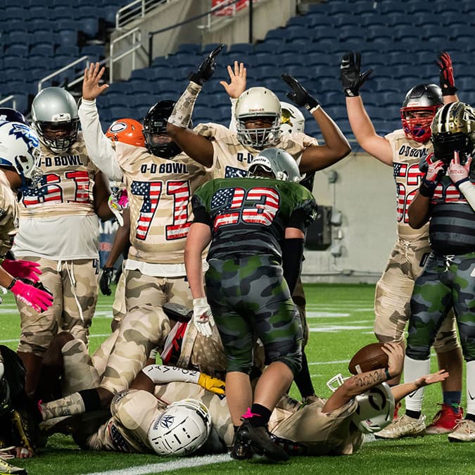 Bowl players celebrating a touchdown in the end zone