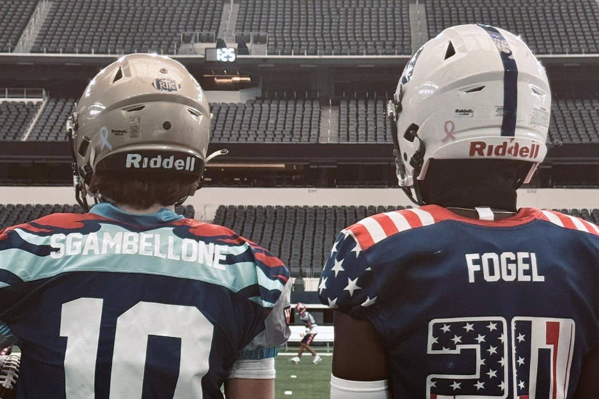 Two All-American Bowl players in their Bowl jerseys looking out at the stadium