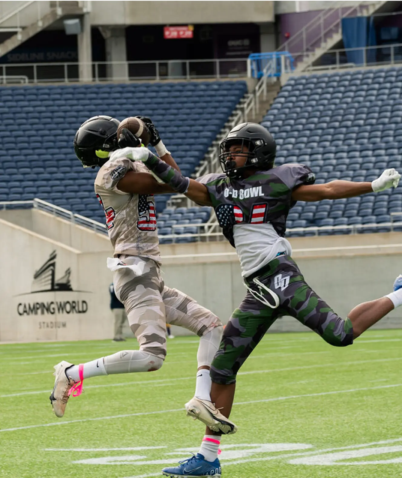 Two Bowl players going up for a catch at Camping World Stadium