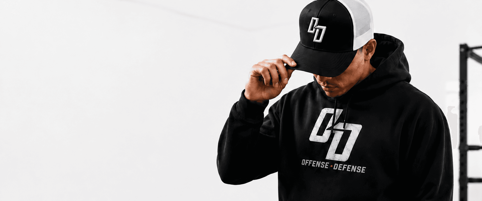Athlete in an O-D trucker cap and the black OD logo hoodie