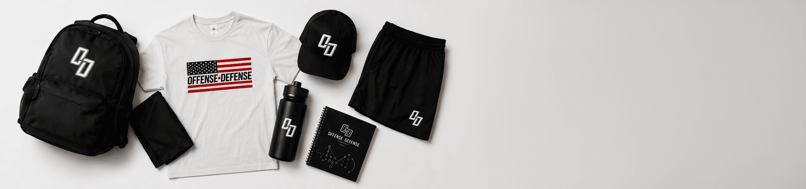 O-D gear laid flat: backpack, flag tee, cap, shorts, bottle and playbook